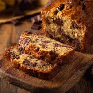 Loaf of chocolate chip banana bread on a wooden table