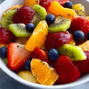 Fresh fruit salad topped with honey lime poppy seed dressing