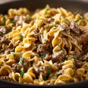 Simple ground beef stroganoff served in a bowl with mushrooms and noodles