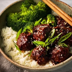 Delicious Sticky Mongolian Beef Meatballs garnished with green onions.